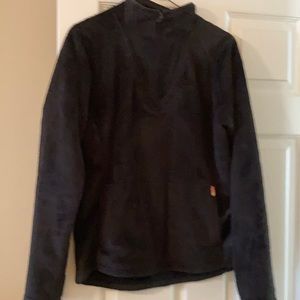 Black 1/4 zip front pouch jacket.